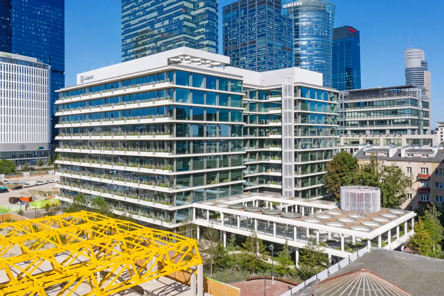 Office House by day, with the yellow trusses of Towarowa 22 in front